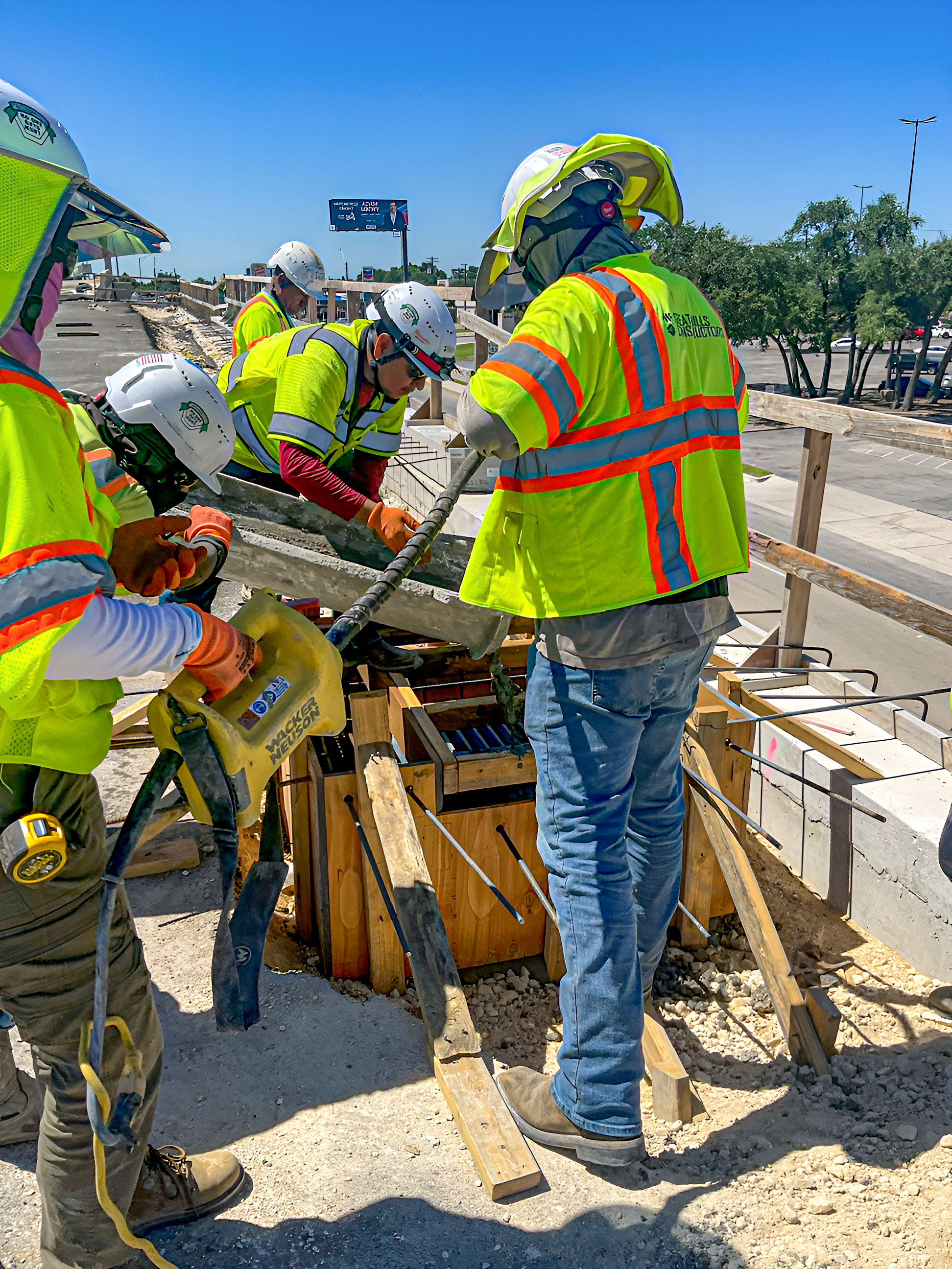 Close up photo of construction crews placing cast for the inlet top